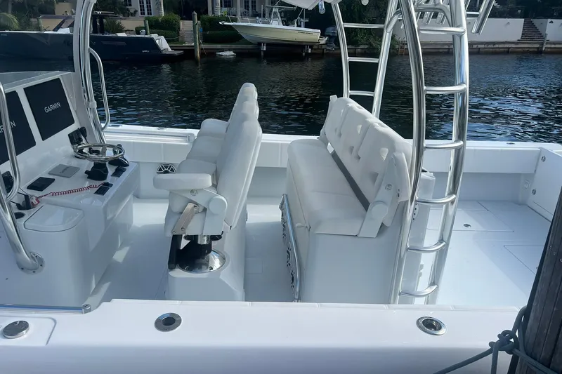Slide: The Image of 2025 Contender 44 ST boat interior with white seating and navigation equipment. - 8