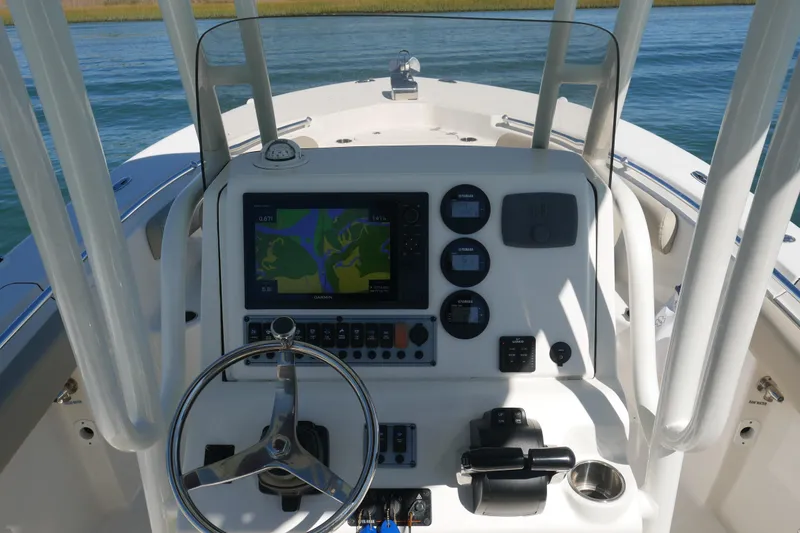 Slide: The Image of 2021 Key West 244 Center Console boat dashboard with steering wheel and navigation system. - 10
