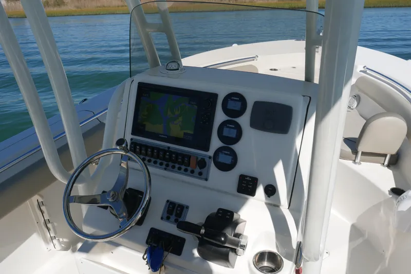 Slide: The Image of 2021 Key West 244 Center Console boat storage compartment with electronic equipment. - 11