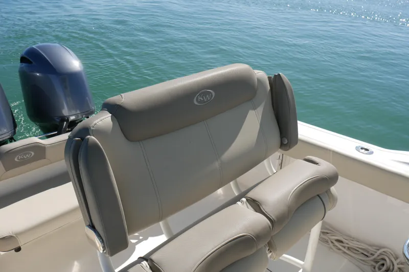 Slide: The Image of 2021 Key West 244 Center Console boat with dual outboard motors on calm water. - 15