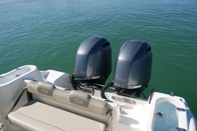 Slide: The Image of 2021 Key West 244 Center Console boat with dual outboard motors on water. - 17