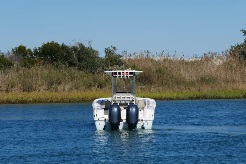 Slide: The Image of 2021 Key West 244 Center Console boat interior with seating, on calm water. - 5