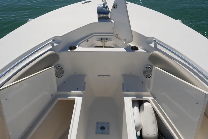Slide: The Image of 2021 Key West 244 Center Console boat on calm water, featuring beige seating and open deck. - 8