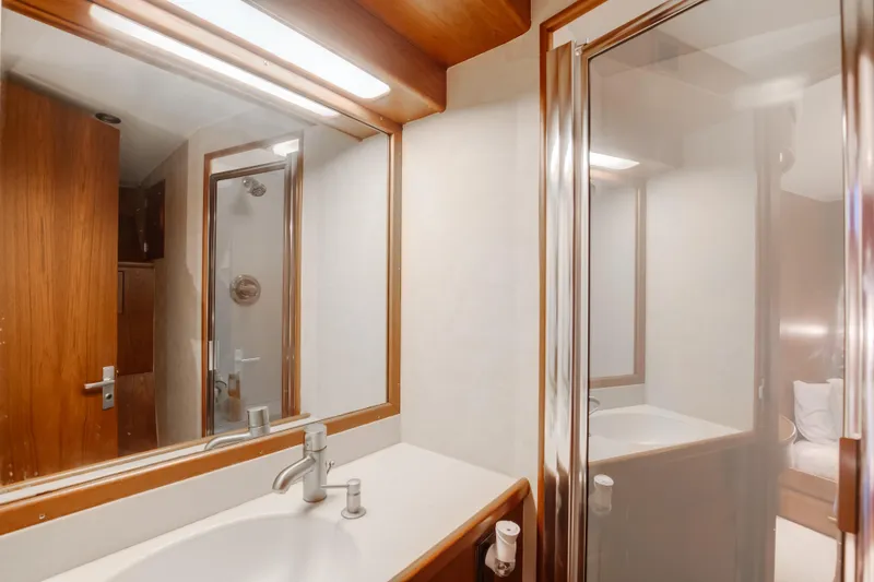 Slide: The Image of Bathroom interior of 1972 Jim Smith Custom Convertible yacht, featuring wood accents and modern fixtures. - 23