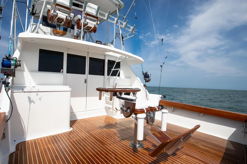 Slide: The Image of 1972 Jim Smith Custom Convertible boat with wooden deck, ocean view, and fishing equipment. - 24