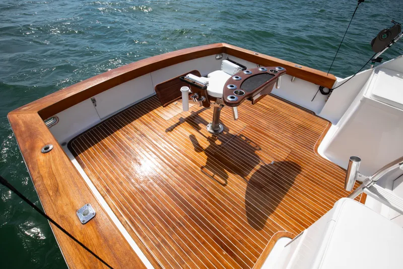 Slide: The Image of 1972 Jim Smith Custom Convertible boat deck with polished wood finish and fishing chair. - 25
