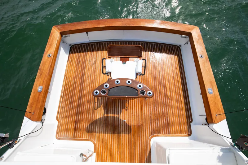 Slide: The Image of 1972 Jim Smith Custom Convertible boat deck with polished wood finish and fishing chair. - 26