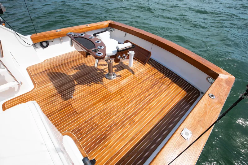 Slide: The Image of 1972 Jim Smith Custom Convertible boat deck with polished wood finish and fishing chair. - 27