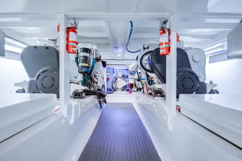 Slide: The Image of Engine room of a 1972 Jim Smith Custom Convertible boat, featuring modern equipment and fire extinguishers. - 32