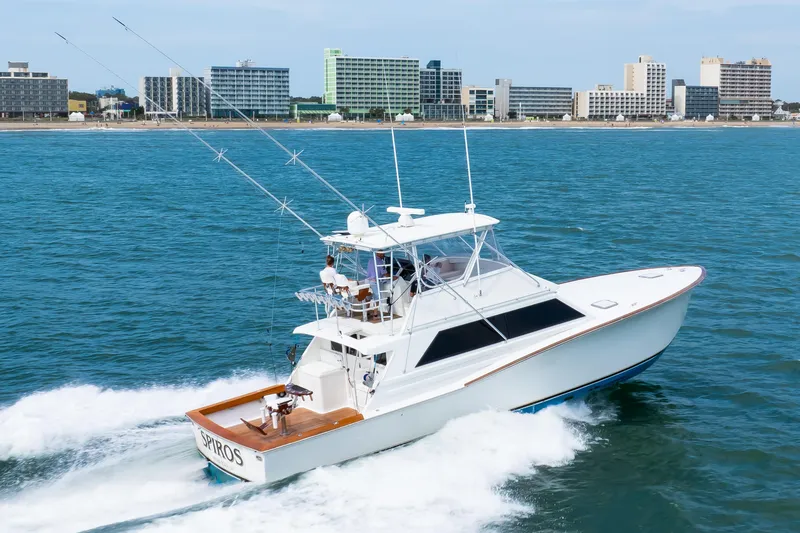 Slide: The Image of 1972 Jim Smith Custom Convertible yacht cruising near a city shoreline. - 5