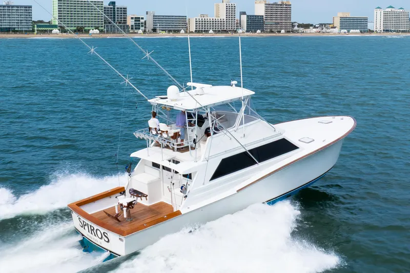Slide: The Image of 1972 Jim Smith Custom Convertible yacht cruising near a city shoreline. - 6