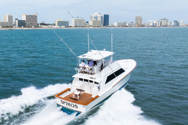 Slide: The Image of A 1972 Jim Smith Custom Convertible yacht cruising near a city skyline. - 7