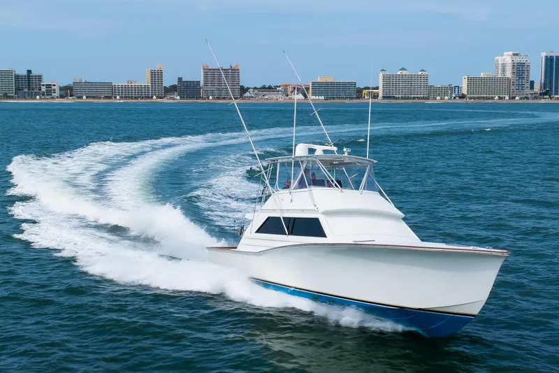 Slide: The Image of 1972 Jim Smith Custom Convertible boat cruising on ocean near city skyline. - 8