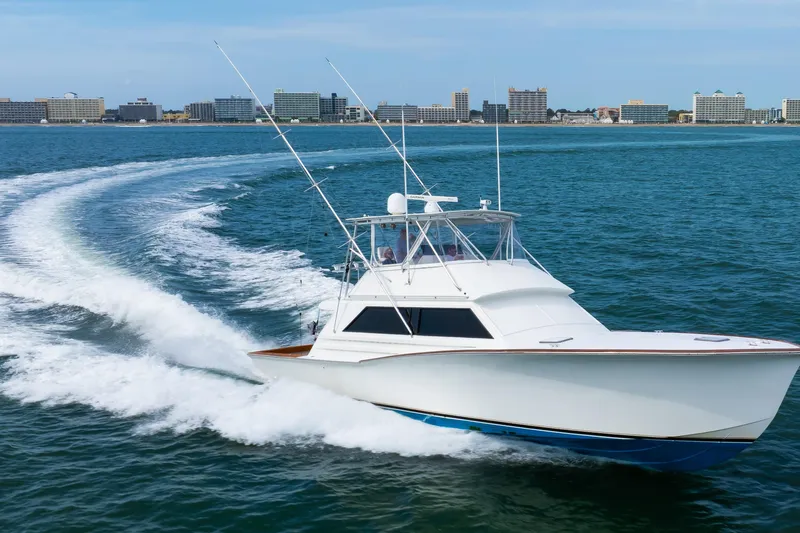 Slide: The Image of 1972 Jim Smith Custom Convertible boat cruising on ocean near city skyline. - 9