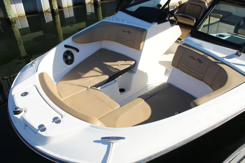 Slide: The Image of 2023 Sea Ray SPX 210 boat interior with tan seating and sleek design. - 10
