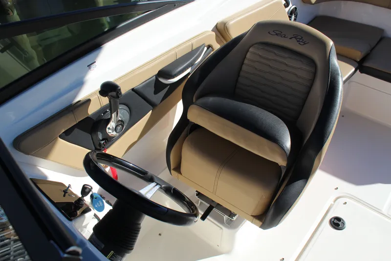 Slide: The Image of 2023 Sea Ray SPX 210 boat interior with steering wheel and captain's seat. - 13
