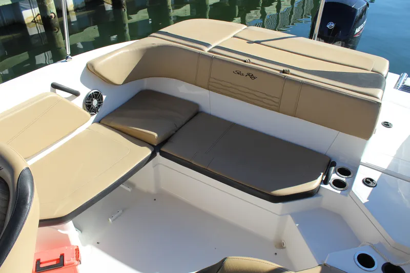 Slide: The Image of 2023 Sea Ray SPX 210 boat interior with beige seating and cup holders. - 14