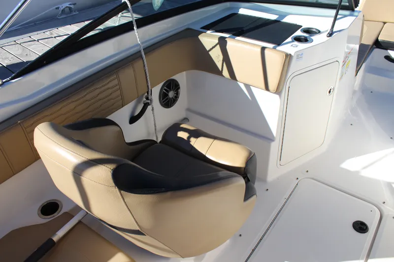 Slide: The Image of 2023 Sea Ray SPX 210 boat interior with tan seating and modern dashboard. - 15
