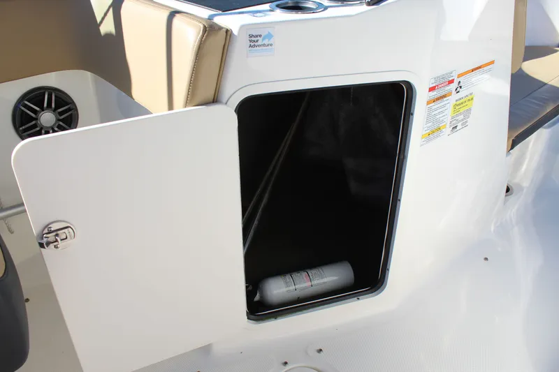 Slide: The Image of Open storage compartment on 2023 Sea Ray SPX 210 boat with visible fire extinguisher. - 18