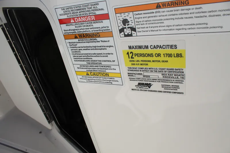 Slide: The Image of Warning labels on 2023 Sea Ray SPX 210 boat, indicating safety and capacity limits. - 19