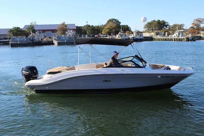 Slide: The Image of 2023 Sea Ray SPX 210 boat cruising on water with a Mercury engine. - 2