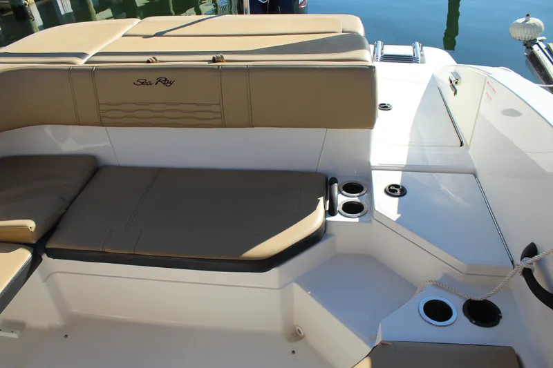 Slide: The Image of 2023 Sea Ray SPX 210 boat interior with tan seating and cup holders. - 20
