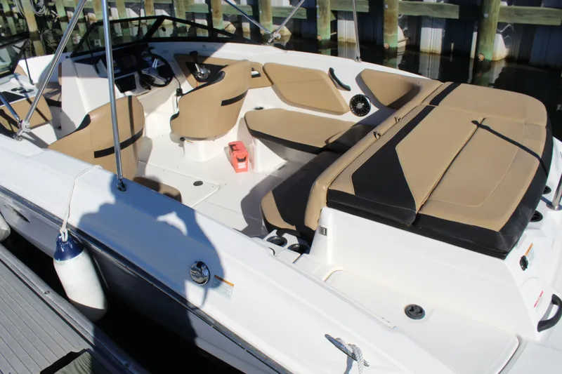 Slide: The Image of 2023 Sea Ray SPX 210 boat interior with tan seating and modern dashboard. - 22