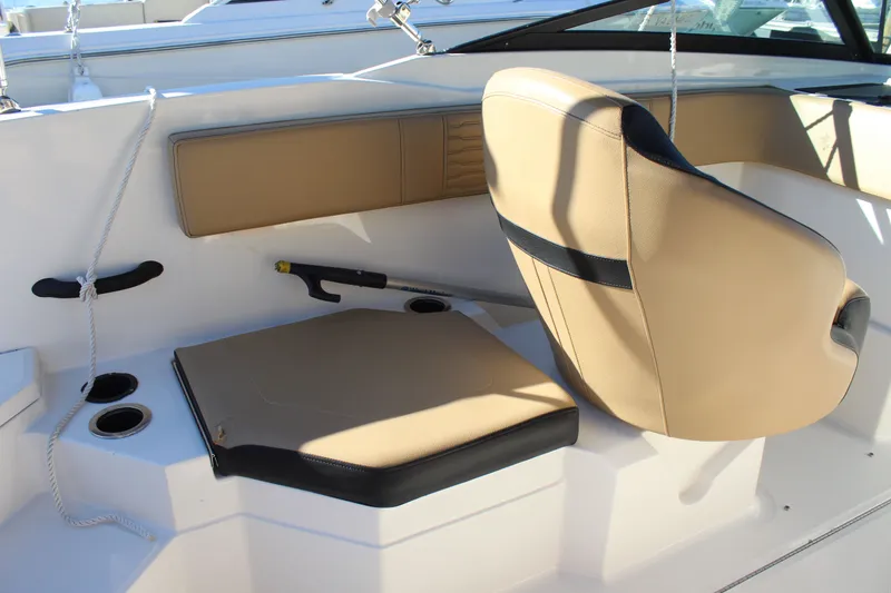 Slide: The Image of 2023 Sea Ray SPX 210 boat interior with tan seating and cup holders. - 23
