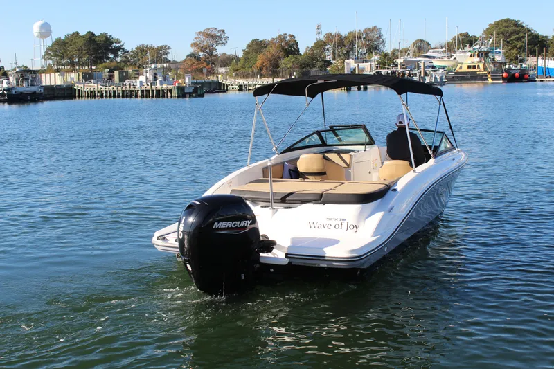 Slide: The Image of 2023 Sea Ray SPX 210 boat named "Wave of Joy" cruising in a marina. - 3