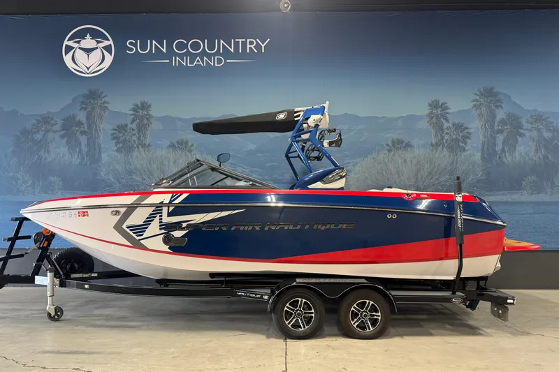 Slide: The Image of 2015 Nautique Super Air Nautique G23 boat on trailer, indoor display setting. - 4