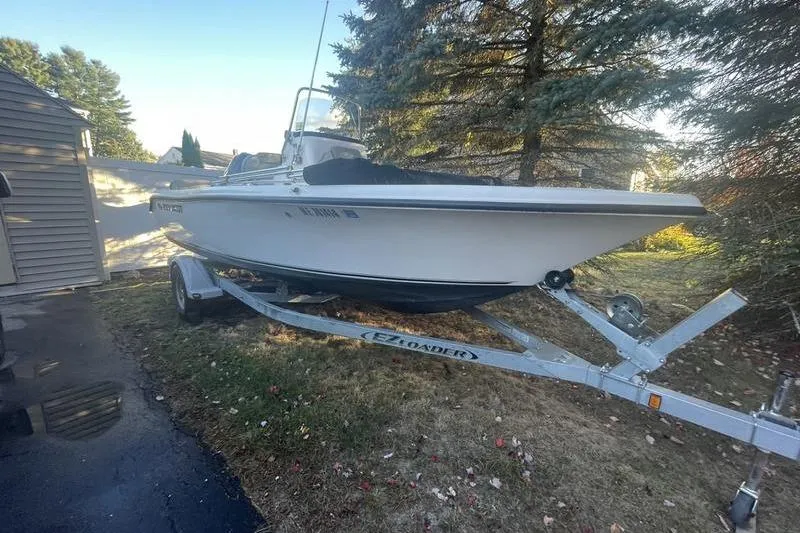 Slide: The Image of 2023 Key West 189 FS boat on trailer, parked outdoors near trees. - 3