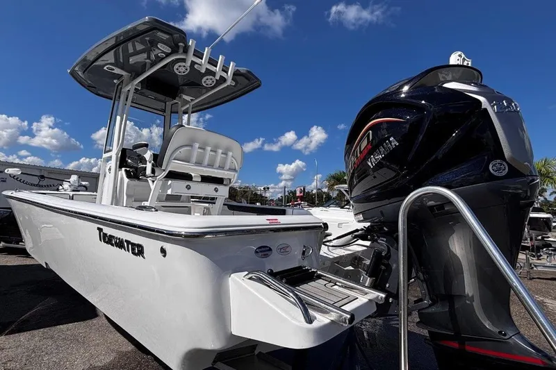 Slide: The Image of 2026 Tidewater 2300 Carolina Bay boat interior with storage compartments and motor. - 10