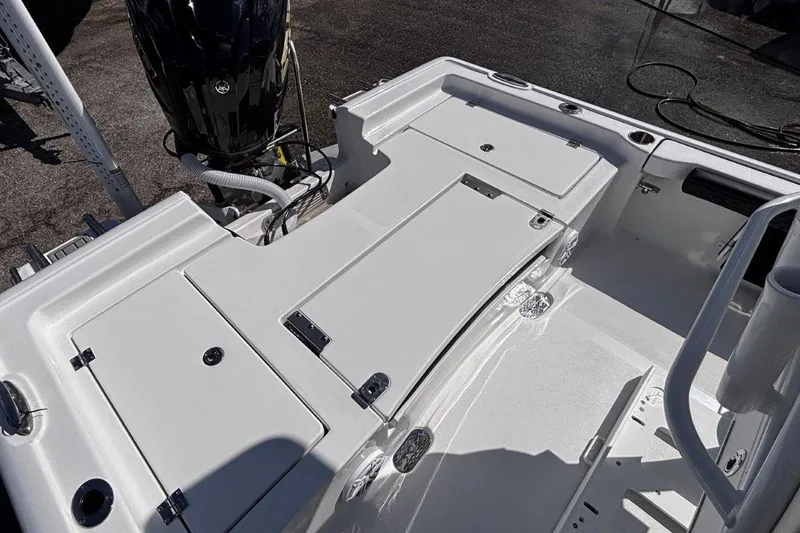 Slide: The Image of Open storage compartment on 2026 Tidewater 2300 Carolina Bay boat, featuring a blue interior. - 14