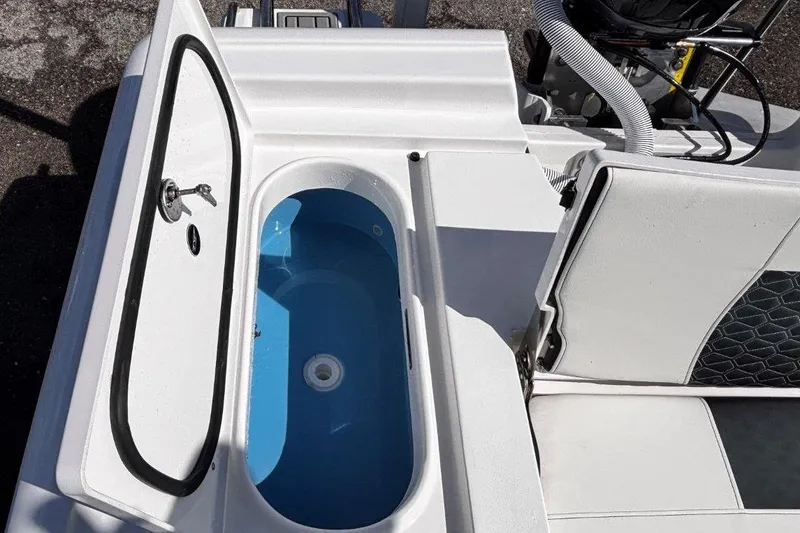 Slide: The Image of 2026 Tidewater 2300 Carolina Bay boat, T-top view against blue sky. - 16