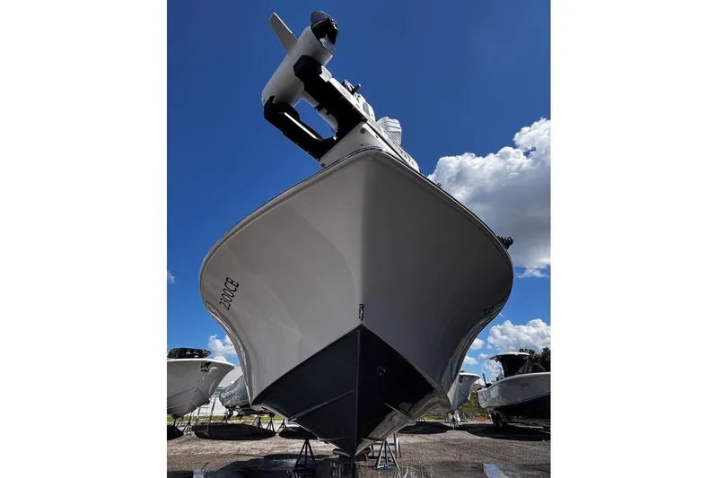Slide: The Image of 2026 Tidewater 2300 Carolina Bay boat under a clear blue sky, showcasing sleek design. - 5