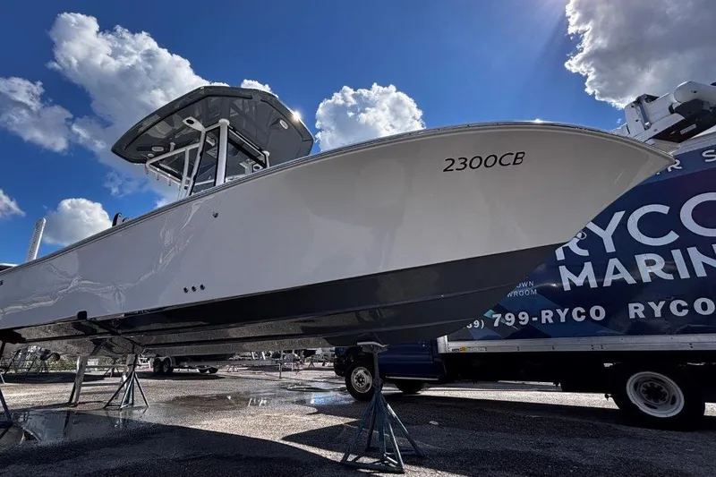 Slide: The Image of 2026 Tidewater 2300 Carolina Bay boat with Yamaha engine under clear blue sky. - 6
