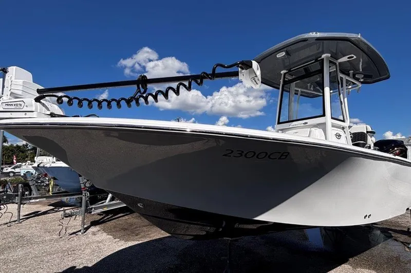 Slide: The Image of 2026 Tidewater 2300 Carolina Bay boat with powerful outboard motor, parked under a sunny sky. - 7