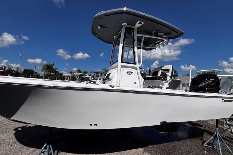 Slide: The Image of 2026 Tidewater 2300 Carolina Bay boat with Yamaha engine, docked under a clear blue sky. - 8