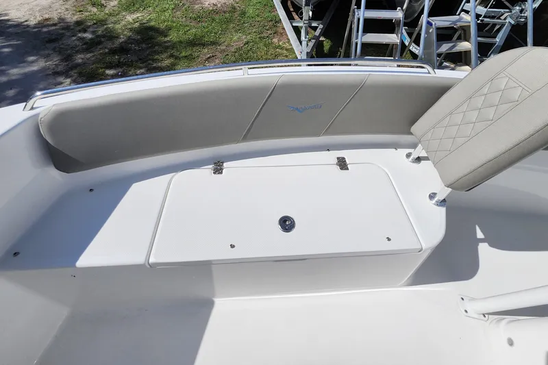 Slide: The Image of 2026 Savannah 2200 Offshore boat interior with cushioned seating and storage compartment. - 11
