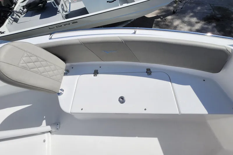 Slide: The Image of 2026 Savannah 2200 Offshore boat interior with cushioned seating and storage compartment. - 14