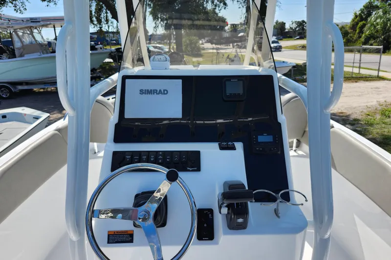 Slide: The Image of 2026 Savannah 2200 Offshore boat dashboard with Simrad display and steering wheel. - 17