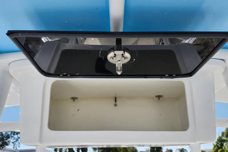 Slide: The Image of Open storage compartment on 2026 Savannah 2200 Offshore boat, featuring a secure latch mechanism. - 19