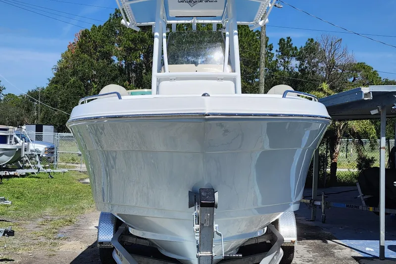 Slide: The Image of 2026 Savannah 2200 Offshore boat on trailer, front view, outdoors. - 2