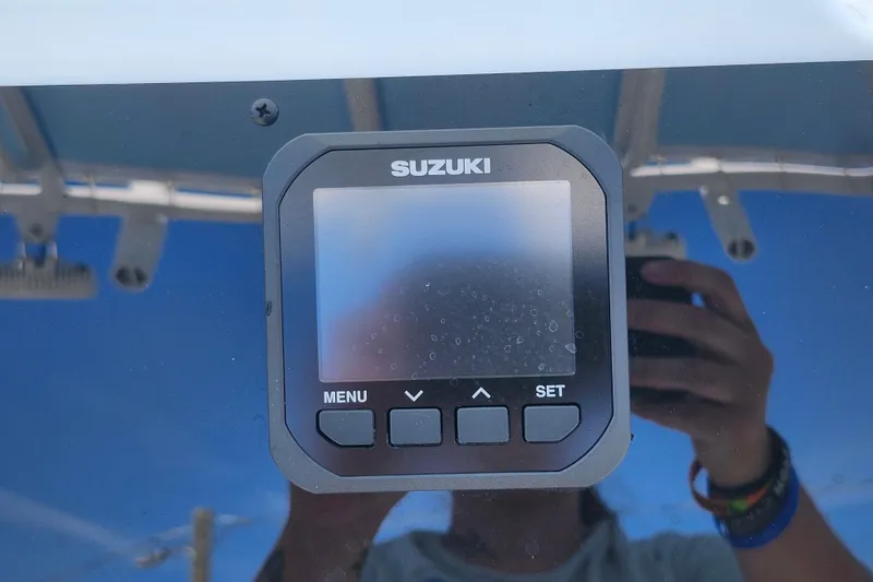 Slide: The Image of Suzuki display on 2026 Savannah 2200 Offshore boat dashboard, reflecting a person taking a photo. - 20