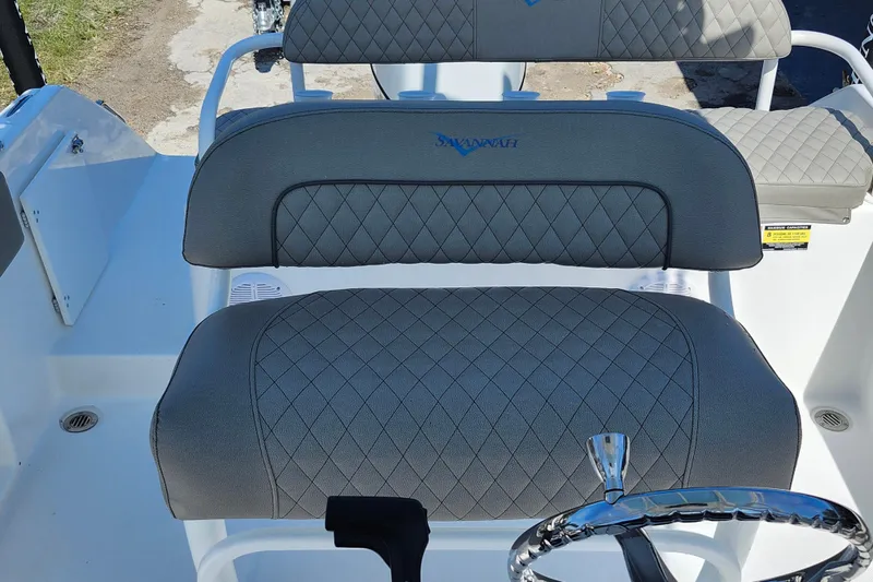 Slide: The Image of 2026 Savannah 2200 Offshore boat interior with diamond-stitched seating and steering wheel. - 25