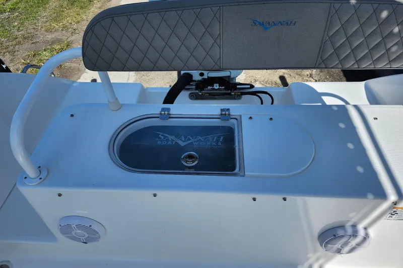 Slide: The Image of 2026 Savannah 2200 Offshore boat interior with storage compartment and speakers. - 29
