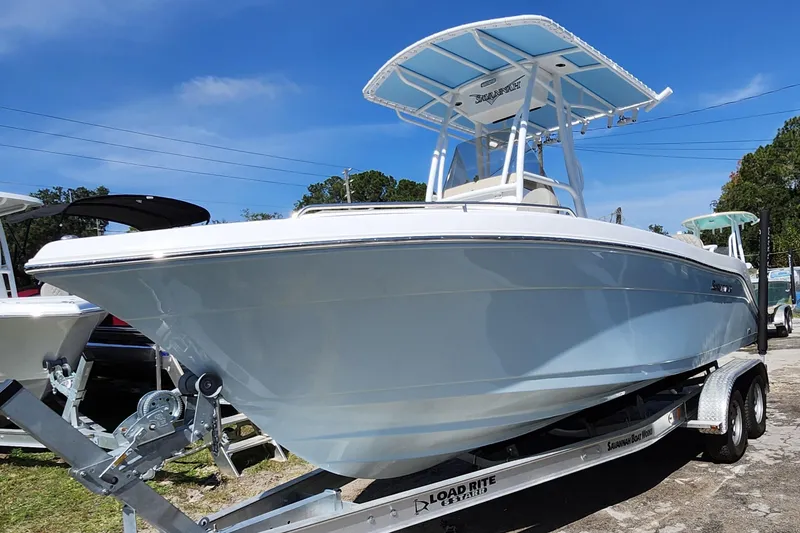 Slide: The Image of 2026 Savannah 2200 Offshore boat on trailer under clear blue sky. - 3