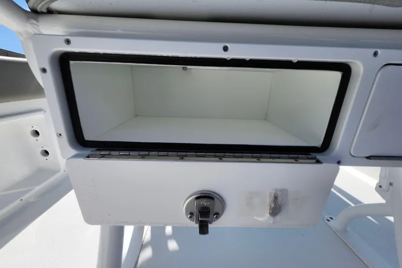 Slide: The Image of Storage compartment on a 2026 Savannah 2200 Offshore boat, featuring a secure latch. - 35