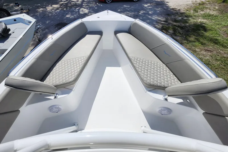 Slide: The Image of 2026 Savannah 2200 Offshore boat interior with cushioned seating and diamond-patterned upholstery. - 7