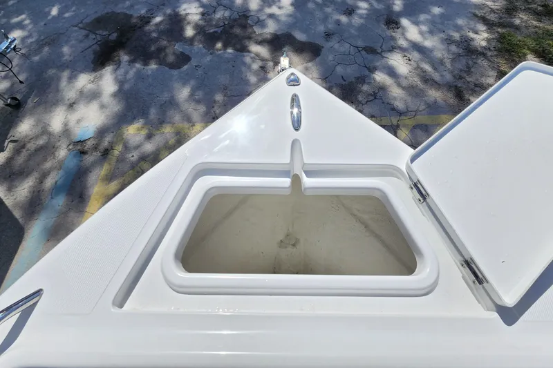 Slide: The Image of 2026 Savannah 2200 Offshore boat with open storage compartment on deck. - 9